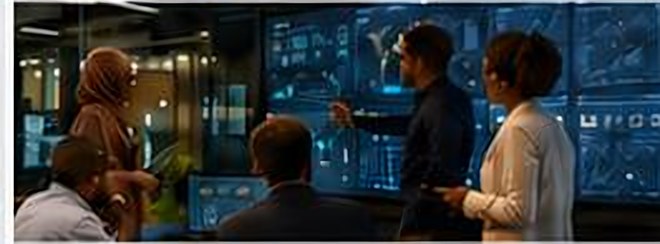 Operators reviewing live dashboards in a control room